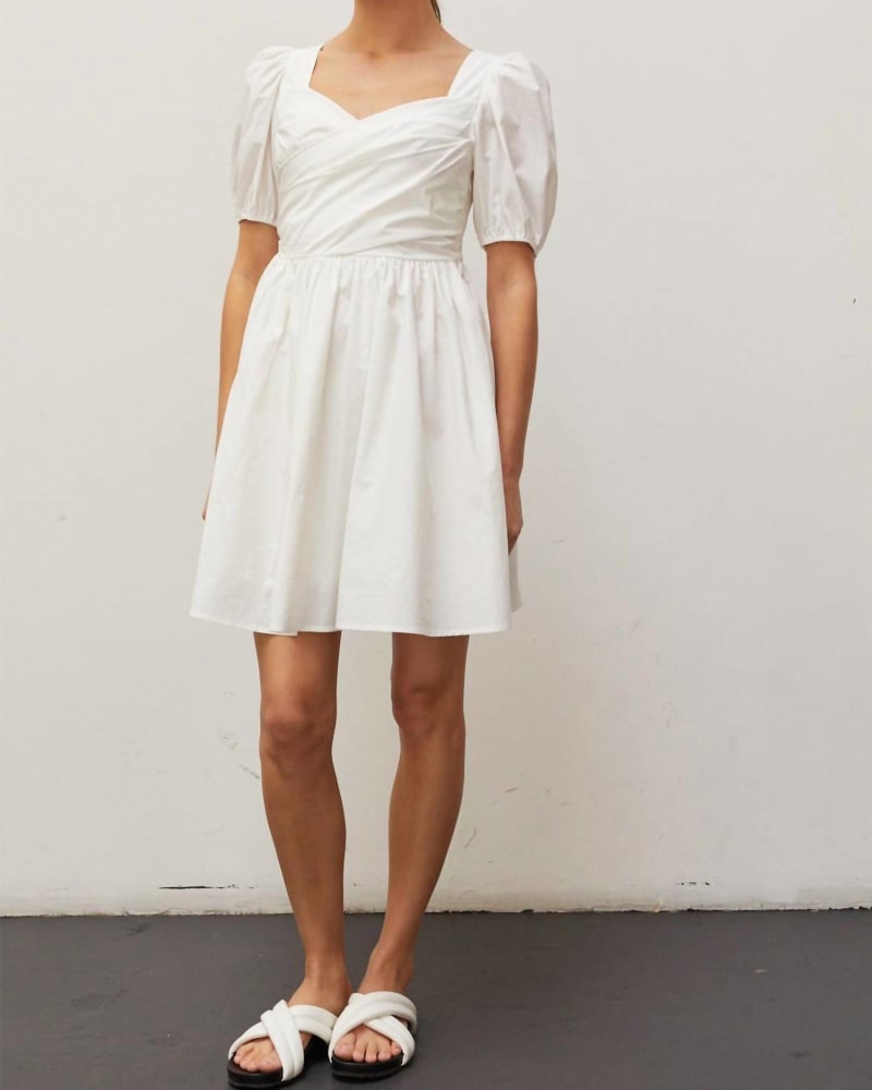 Front of a model wearing a size Large Natasha Pleated Front Mini Dress in White in White by CRESCENT. | dia_product_style_image_id:335345